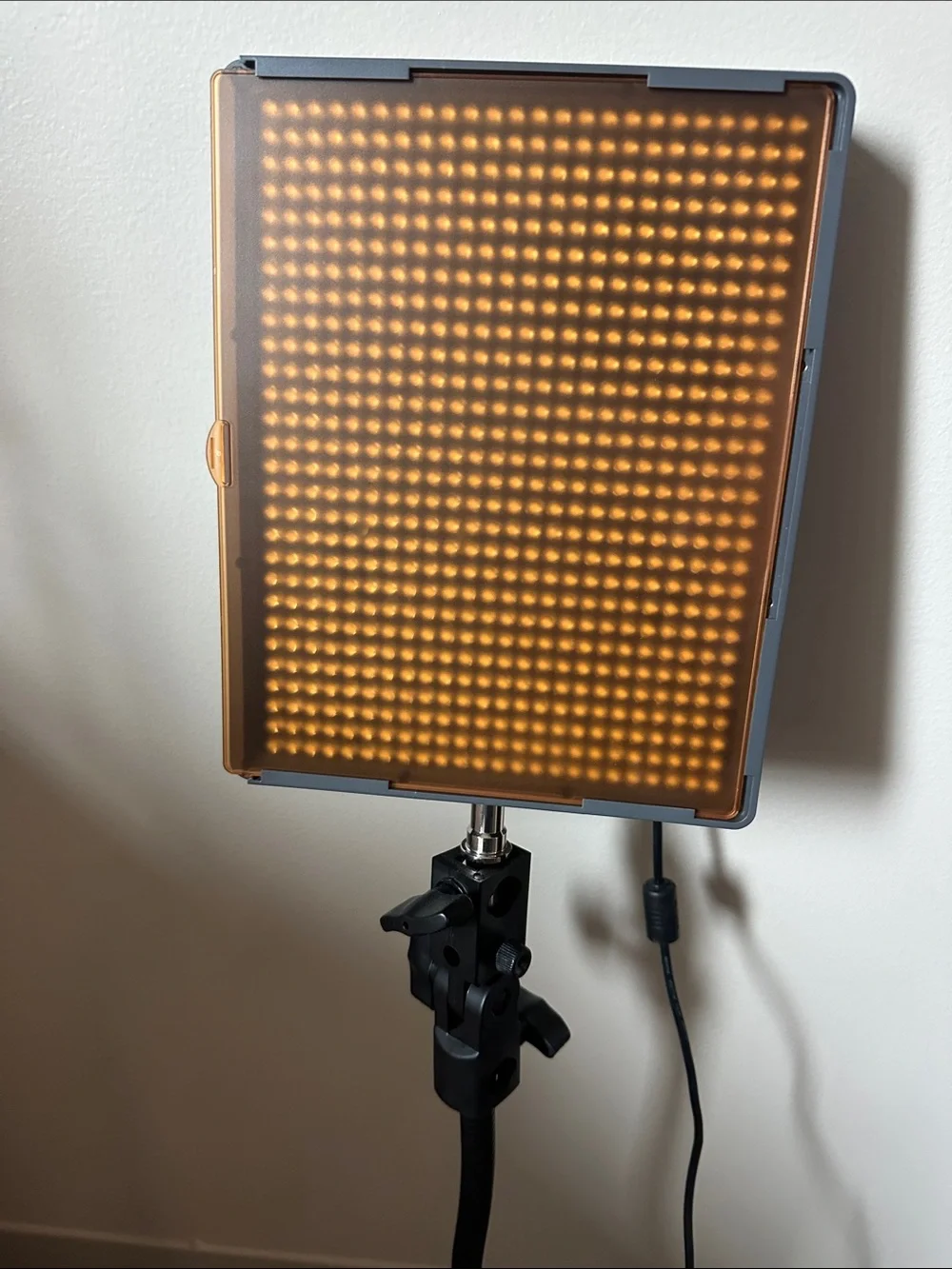 Aputure Amaran HR672W LED Video Light Panel with stand/holder and orange filter.